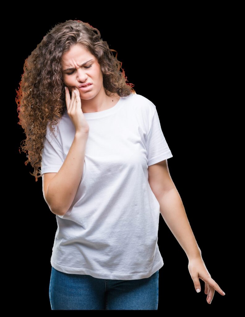A woman touches the side of her face as though she is in pain due to a dental emergency.