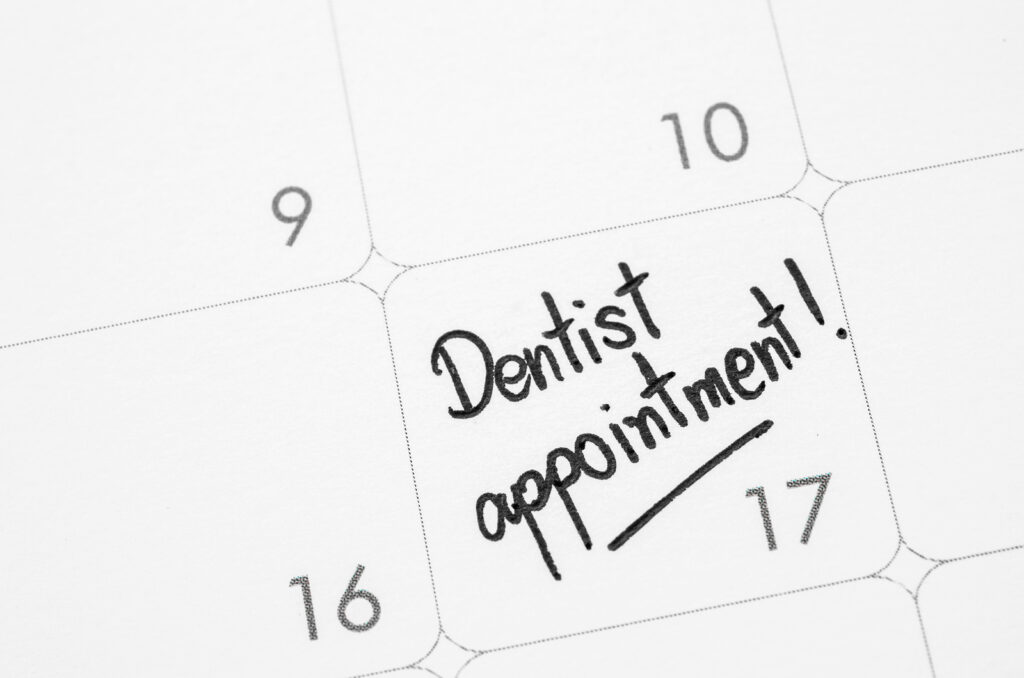 Image of a calendar date labeled with "Dentist appointment!" representing a reminder for an upcoming teeth cleaning.
