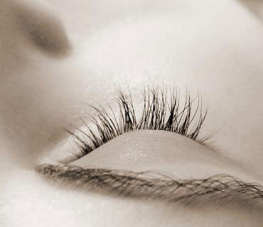 Close-up of a woman's eye, which is closed in a state of relaxation, free from any anxiety.