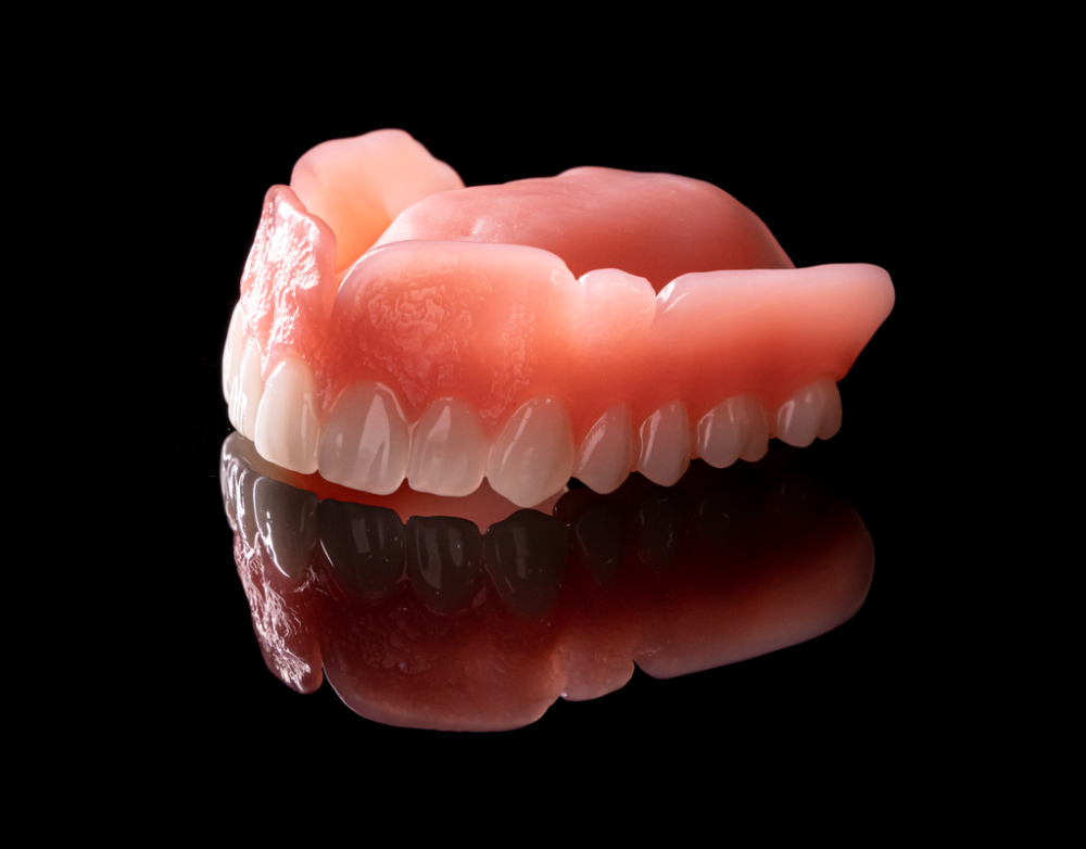 Photo of an upper set of dentures made from Portrait premium teeth.