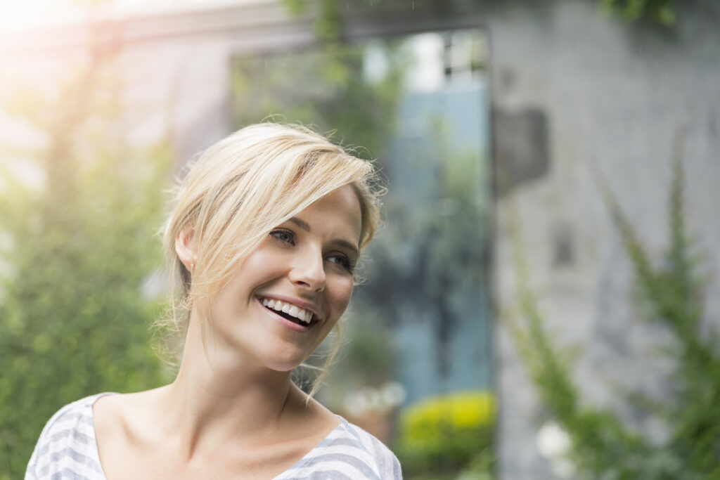A woman smiles a beautiful smile.