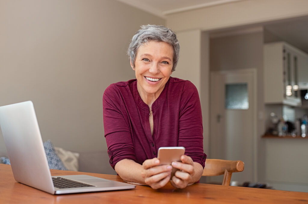 A woman smiles a beautiful smile. Quality dentures are comfortable and aesthetic.