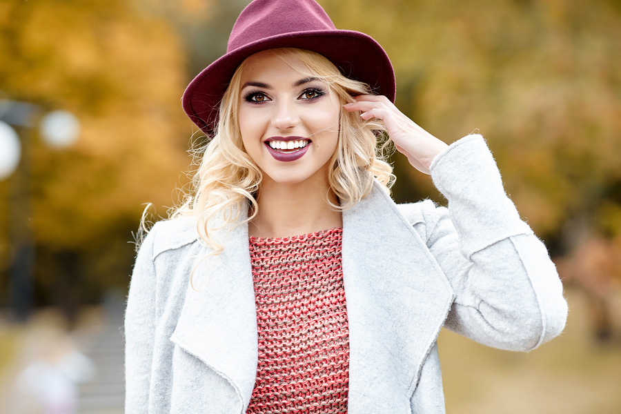 Photo of a woman showing a bright smile, as though she has received whitening treatment.